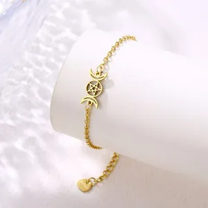 Detailed close-up of golden stainless steel bracelet with triple goddess moon and star charms