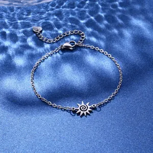 Detailed shot of silver sun pendant bracelet with lobster clasp and heart charm extension