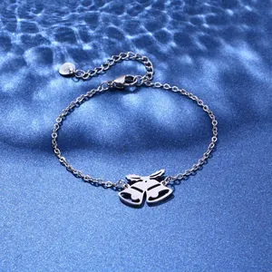 Macro view of silver S925 heart charm and lobster clasp on a double bell bracelet