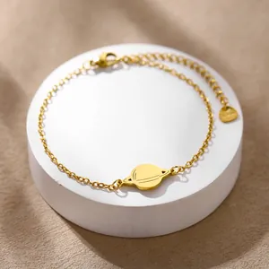 Polished gold Saturn pendant bracelet with adjustable O-link chain and lobster clasp