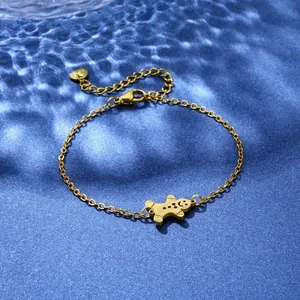 Detail of gold-plated stainless steel bracelet featuring a cute gingerbread man pendant