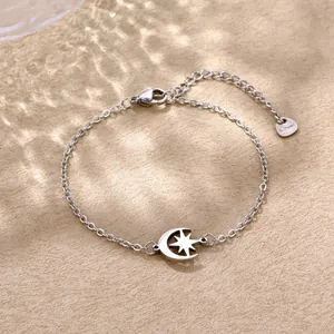 Macro shot of stainless steel bracelet featuring star-moon charm and heart S.Steel tag