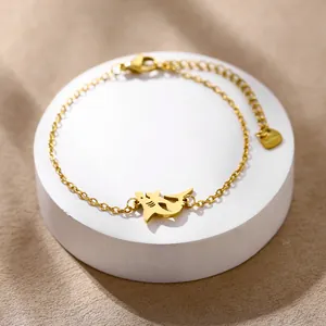 Polished stainless steel shark pendant bracelet in gold finish on a circular stand