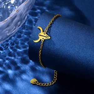 Detailed macro view of a gold stainless steel bracelet with a hollow bull head charm