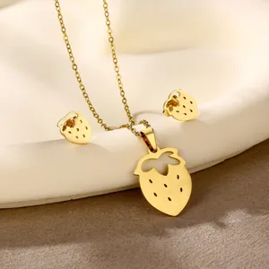 Golden stainless steel jewelry set featuring strawberry pendant necklace and matching stud earrings