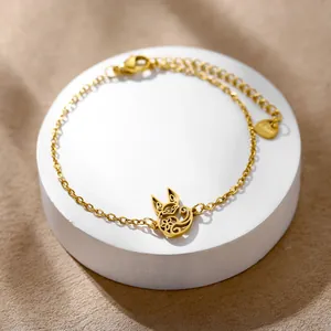Detailed macro view of a golden stainless steel link bracelet with hollow animal charm