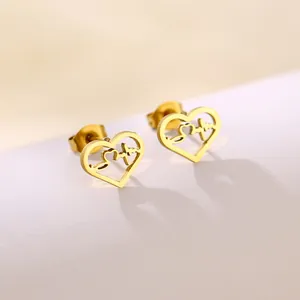 Polished gold stainless steel heart studs with heartbeat line design on beige background