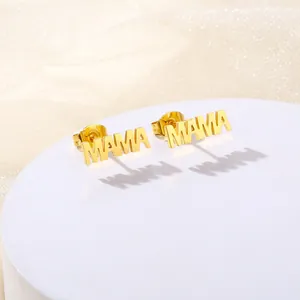 Polished gold MAMA stud earrings for women presented on a decorative white stand