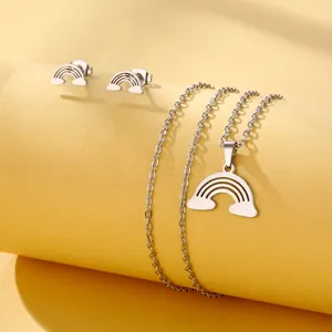 Close-up of a silver stainless steel rainbow and cloud jewelry set with smooth finish