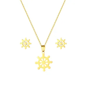 Gold stainless steel nautical ship wheel necklace and earring jewelry set on white background