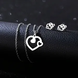 Detail of a minimalist heart-shaped stainless steel necklace and earring jewelry set
