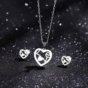 Macro view of silver heart jewelry set with LOVE engraving on sparkling black background