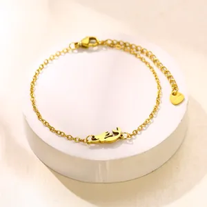 Elegant gold stainless steel mermaid chain bracelet with a cat-shaped pendant on a white stand