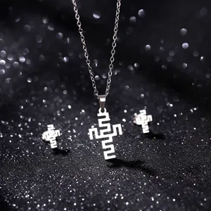 Detailed view of polished stainless steel jewelry set with geometric cross patterns