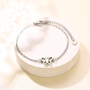 Minimalist silver stainless steel bracelet featuring a delicate hollow butterfly pendant