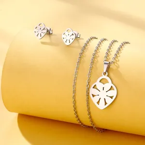 Close-up of hollow heart stainless steel jewelry set on aesthetic display stand