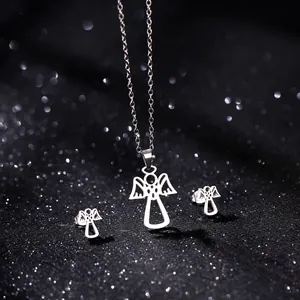 Close-up of a minimalist stainless steel angel necklace and earring set on a black background