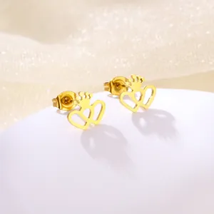 Detailed close-up of golden crown heart stud earrings on a pearly white pedestal