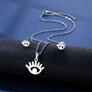 Detailed view of silver stainless steel daisy and cat jewelry set on display