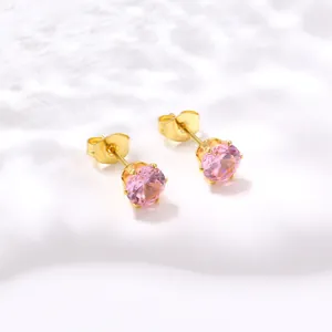 Gros plan de boucles d'oreilles clous avec pierre rose et sertissage à quatre griffes
