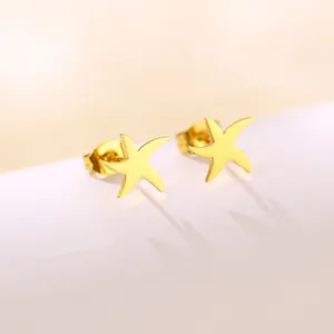 Macro shot of gold starfish stud earrings with a polished metallic finish and refined texture