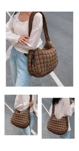 Close-up of brown quilted hobo bag featuring soft puffer texture and spacious design