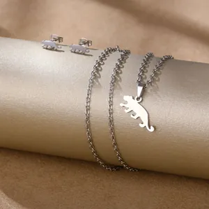 Detailed view of polished leopard pendant necklace and stud earrings set on display