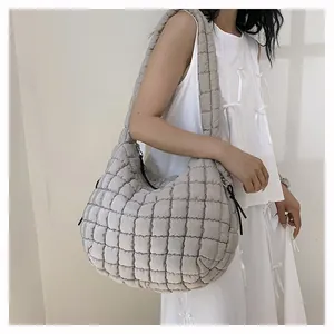 Detail of grey quilted hobo bag featuring soft padded texture and large capacity
