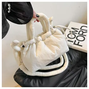 Detailed macro view of white quilted bubble bucket bag with adjustable drawstring closure