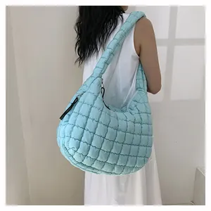 Model wearing light blue quilted cloud bag showing spacious capacity and soft texture
