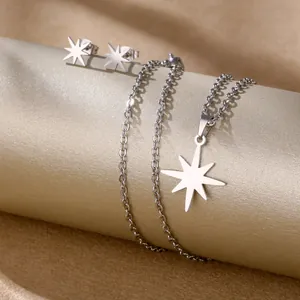 Macro shot of silver octagonal star jewelry set including necklace and stud earrings