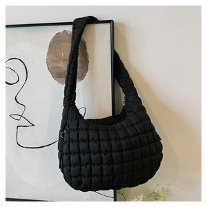 Close-up of black quilted cloud bag showing the puffy texture and seamless shoulder strap