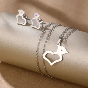 Detailed view of silver stainless steel jewelry set with heart and animal cutout charms