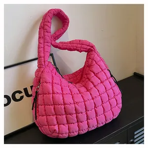 Detail of bright pink quilted puffer bag showing the texture and stitching