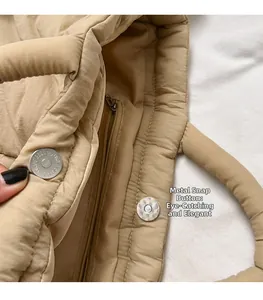 Macro detail of high-quality metal magnetic buckle on beige quilted puffer bag