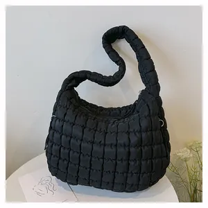 Close-up of black quilted puff cloud bag with elegant pleated texture.