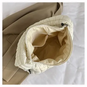Detailed interior of quilted cloud bag showing spacious storage and inner slip pocket
