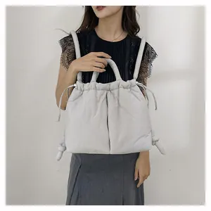 Close-up of lightweight quilted puffer drawstring bag with premium padded texture detail