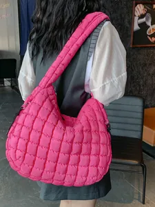 Pink quilted cloud shoulder bag featuring puffy padded design and large tote capacity