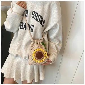 Close-up of handmade crochet sunflower bucket bag with drawstring and knit texture