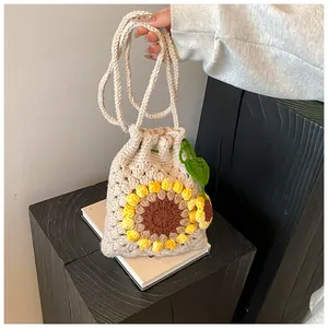 Macro detail of handmade crochet sunflower bag with yellow petals and knit textures
