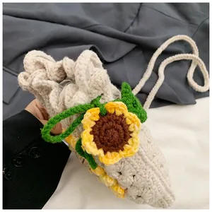 Close-up of hand-knitted cream bucket bag featuring detailed crochet sunflower pattern