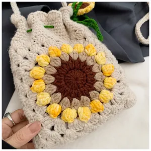 Detailed close-up of handmade crochet sunflower bucket bag with yellow knitted petals