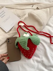 Handmade strawberry crochet crossbody bag with red knit texture and green leaf detail