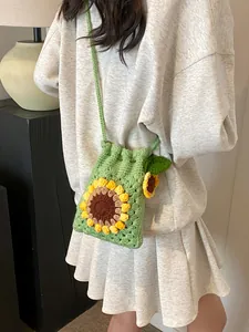 Handmade green crochet sunflower bucket bag with drawstring closure and woven strap