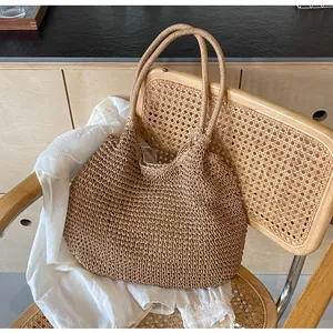 Detail of a handmade straw tote bag with woven texture on a vintage chair