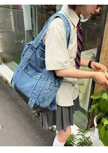 Detail of vintage patchwork denim tote bag with functional pockets for students