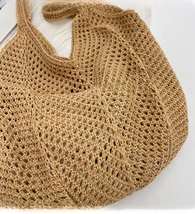 Close-up detail of khaki woven tote bag showing intricate handmade hollow mesh texture