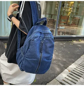 Detail van de gewassen denim rugzak met diepblauwe textuur en zijvak voor dames
