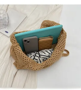Top view showing large capacity of woven tote bag with tablet, phone and wallet inside